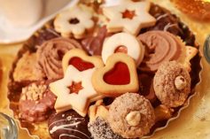 Detail of delicious Christmas cookies with candles in golden tone